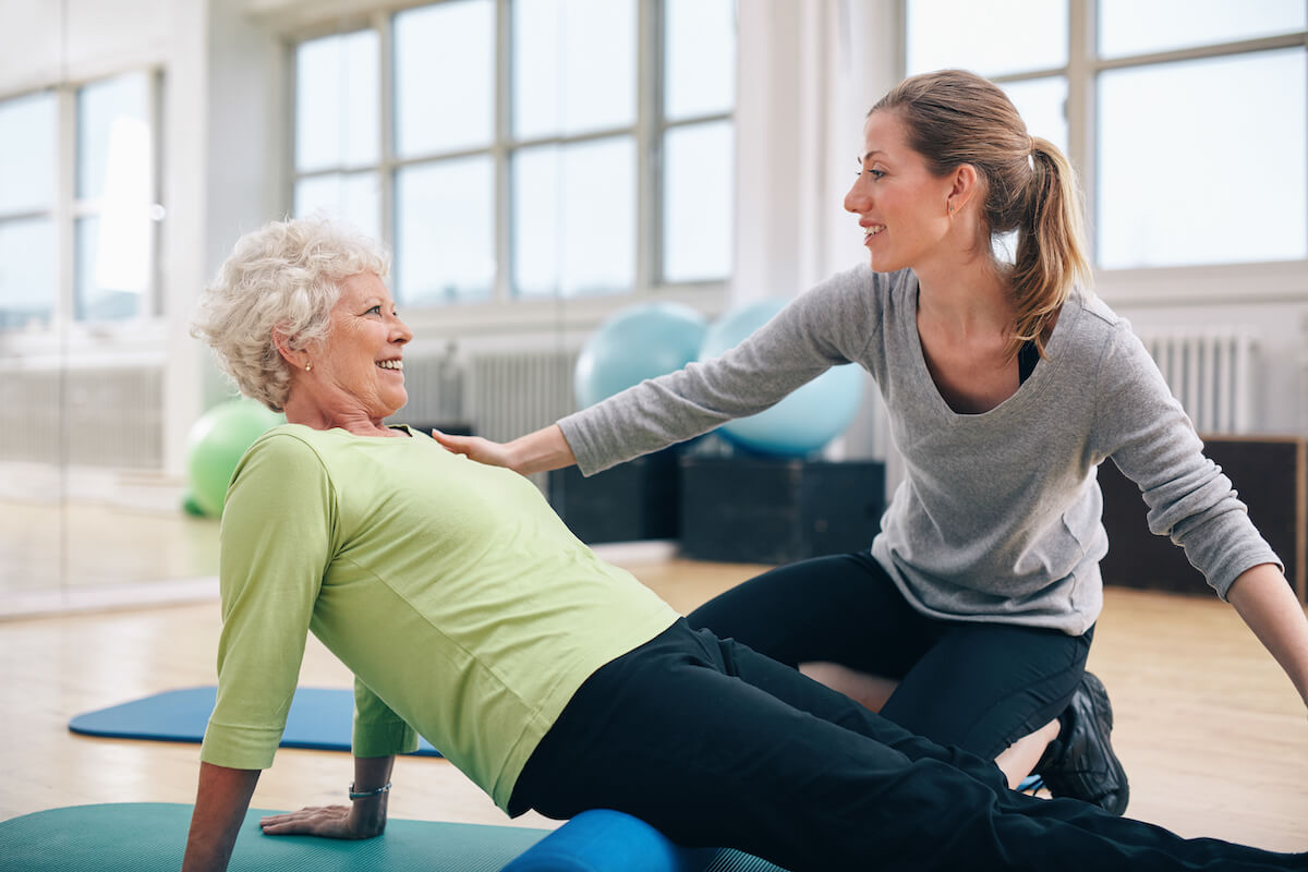 Older woman exercising in a senior living community