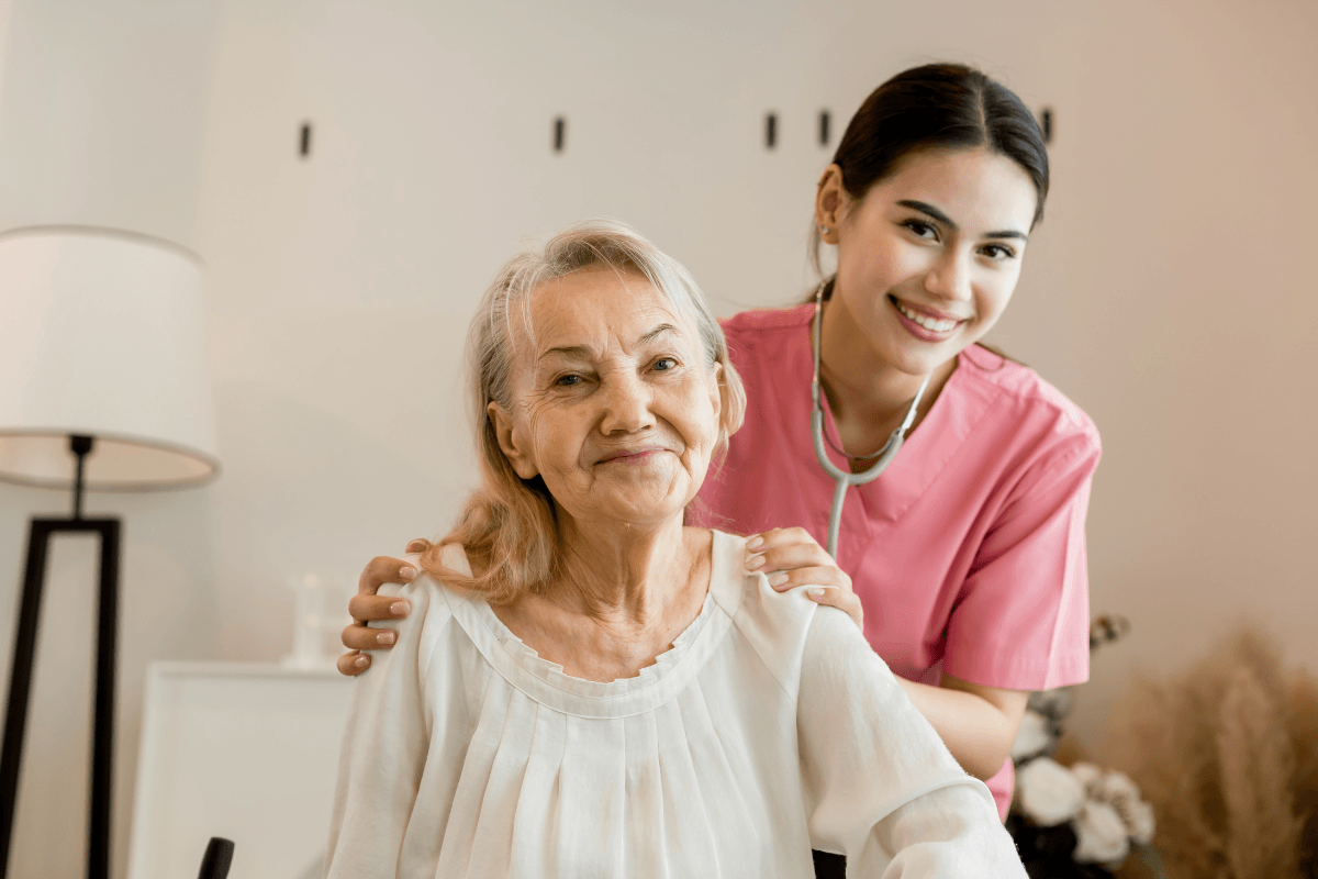 Young professional confident skilled woman doctor visiting old patient lady at home for treatment control care giving.